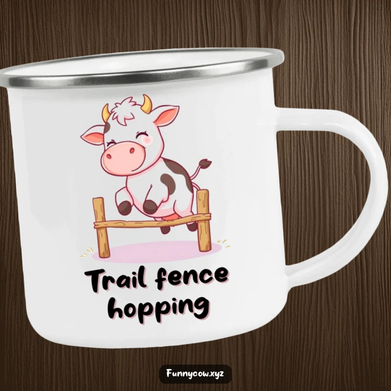 Funny camping mug depicting a giggling cow with wobbly legs attempting to jump a small fence, perfect for outdoor humor.