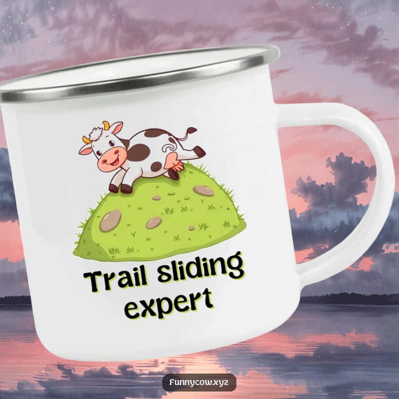Funny camping mug with a cow joyfully sliding down a grassy hill on its behind, for outdoor fun.