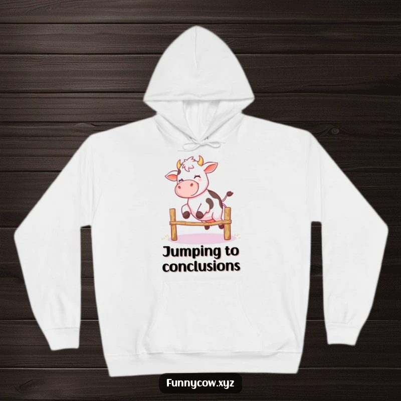 Funny hoodie showing a giggling cow with shaky legs making a valiant, albeit unstable, attempt to jump a small fence.