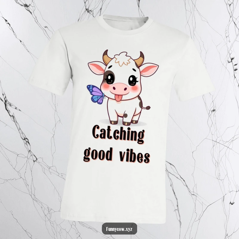 Funny cow t-shirt featuring a cow with its tongue sticking out playfully, trying to catch a butterfly.
